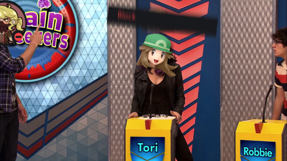 an image from a tv show where someone named Tori is attending a game show, and is having a car battery thrown at her - she is adited to be Prism, the battery is the discord 'block' button, and the thrower is Ryan